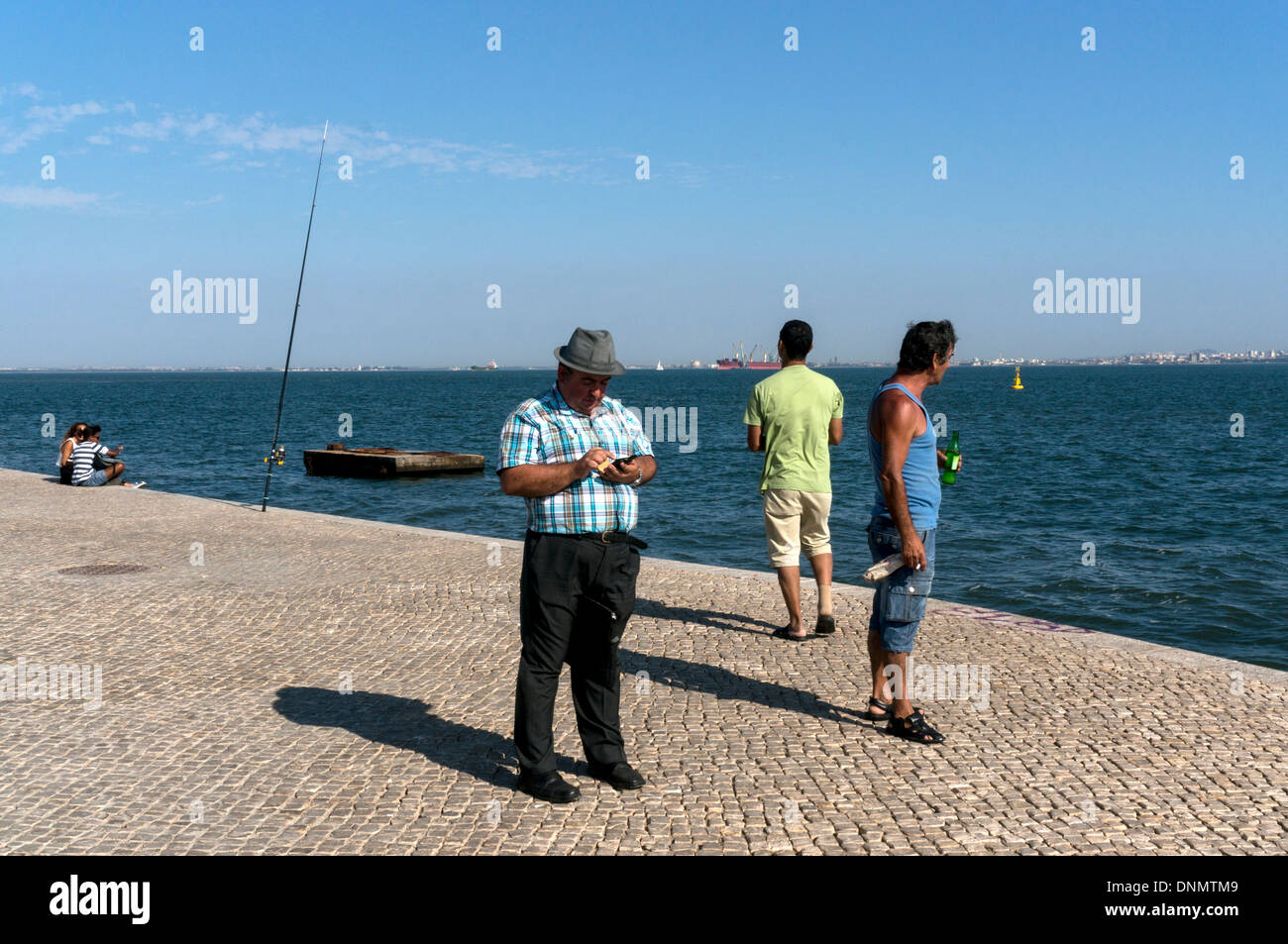 Couple Standing on Concrete Platform by Sea Shore Fishing · Free Stock Photo