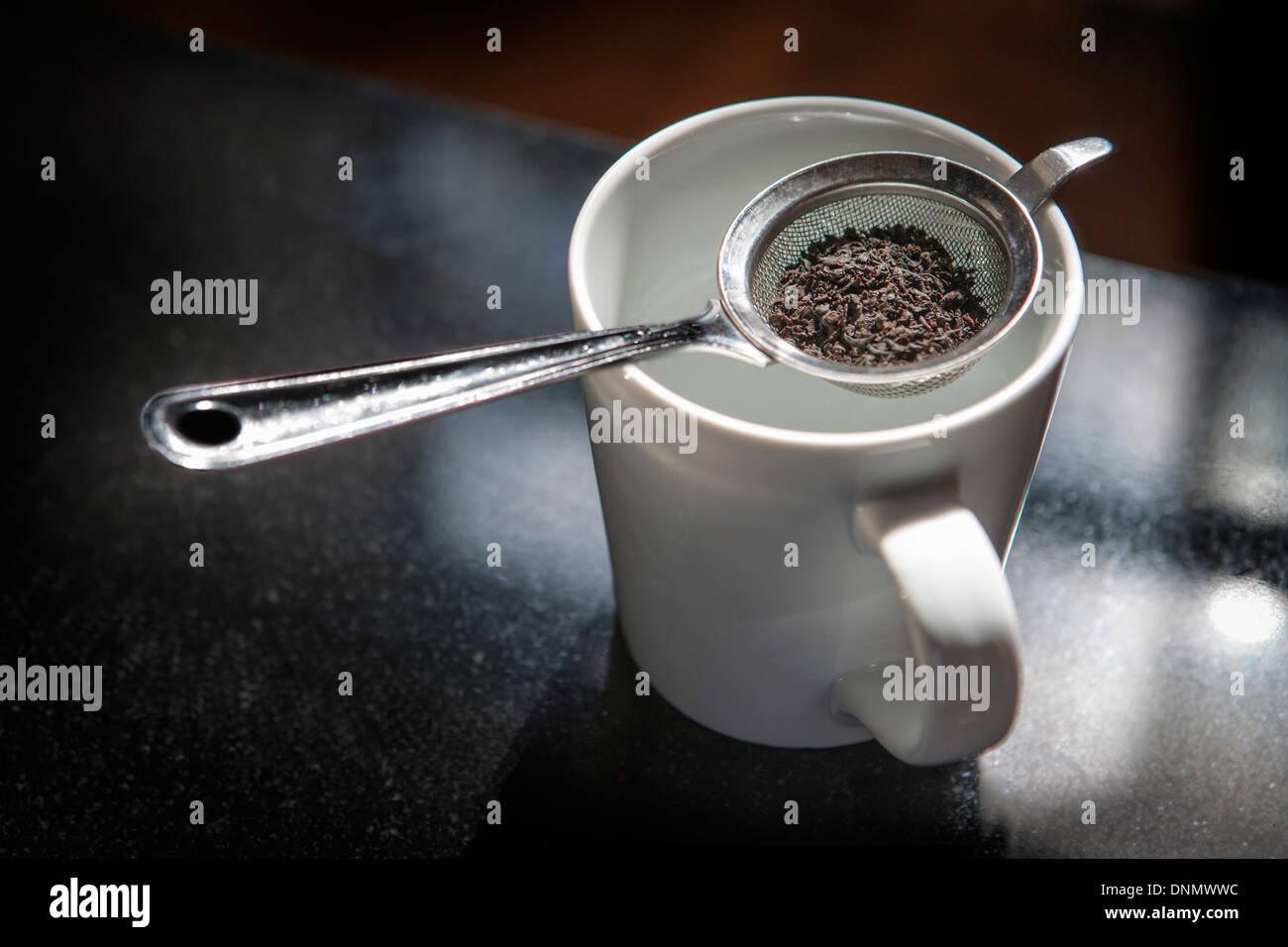Loose Tea in Strainer Above White Cup Stock Photo Alamy