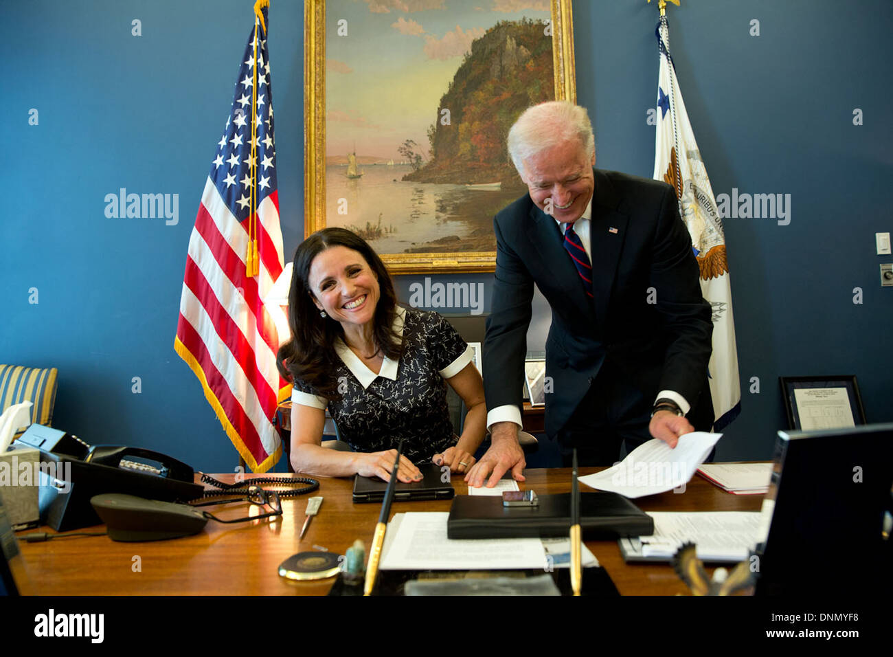 US Vice President Joe Biden jokes with actress Julia-Louise Dreyfus, star of the HBO show Veep, in his West Wing office of the White House April 12 2013 in Washington, DC. Stock Photo