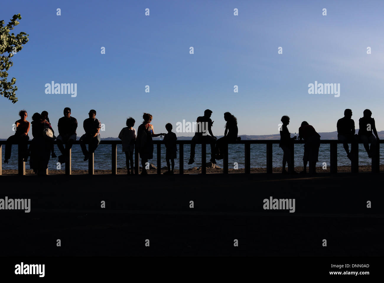 Bolsena, Italy, silhouette, people look to Lake Bolsena Stock Photo
