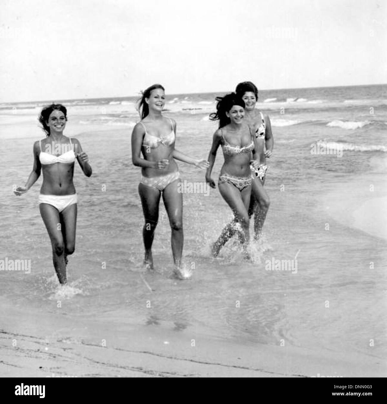 Bikini models running on the beach: Pensacola, Florida Stock Photo