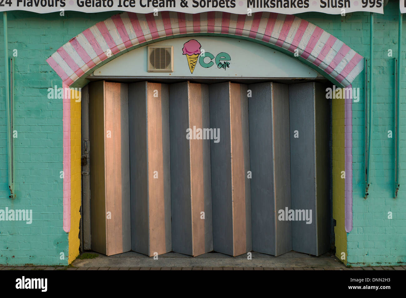 Ice cream kiosk, closed, shuttered, pink, green Stock Photo