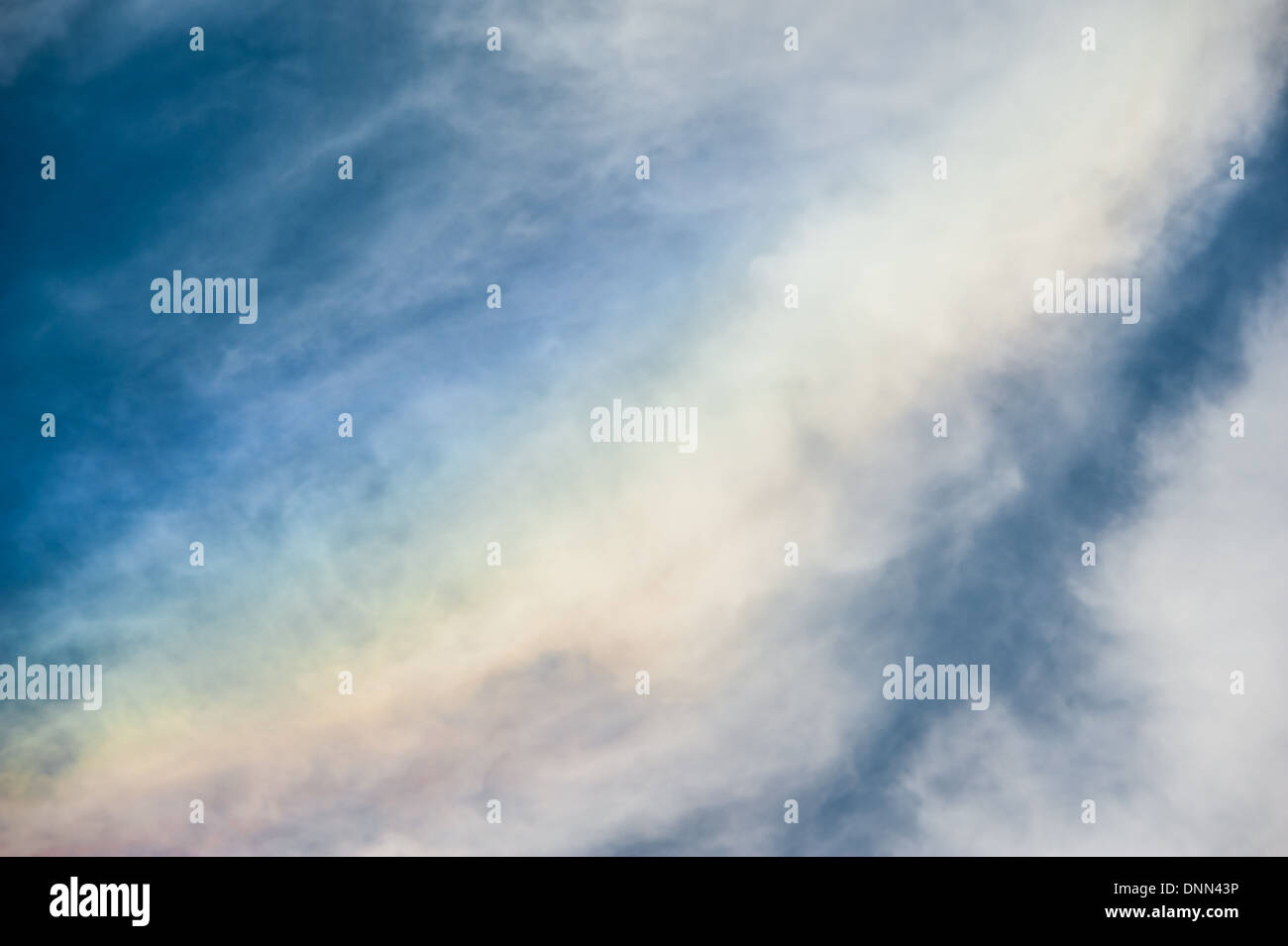 The abstract beauty of rainbow clouds (or 'fire rainbows') caused by sunlight passing through ice crystals. Stock Photo
