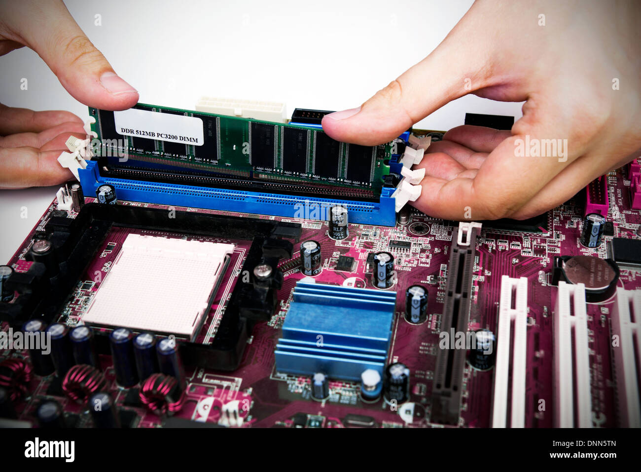 Man installing memory. PC motherboard RAM upgrade Stock Photo