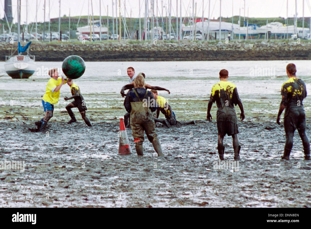 traditional game of mud football on langstone locks mud flats portsmouth england uk Stock Photo