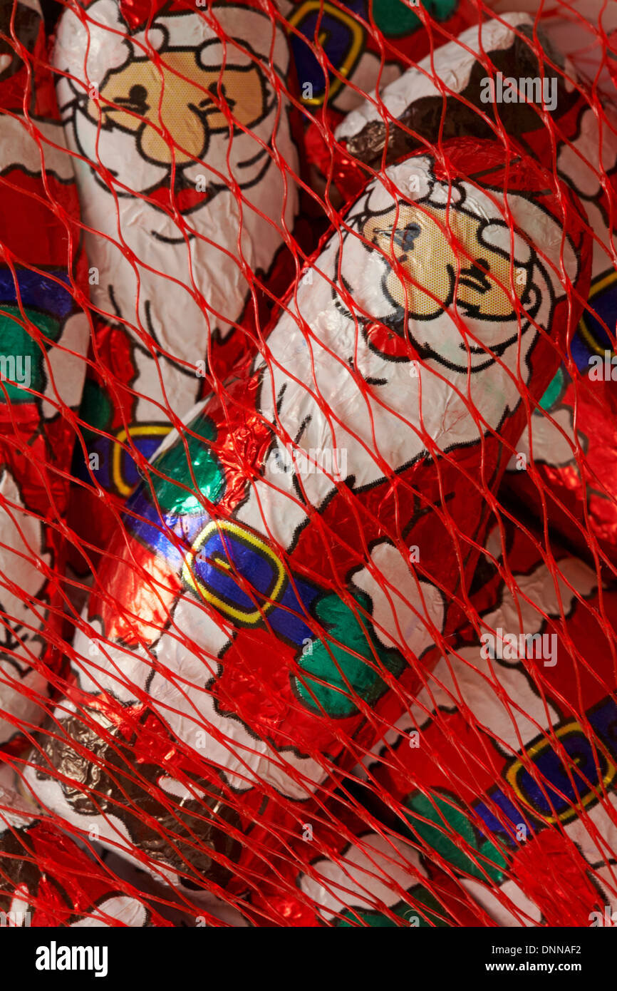 solid milk chocolate santas in netting ready for Christmas Stock Photo