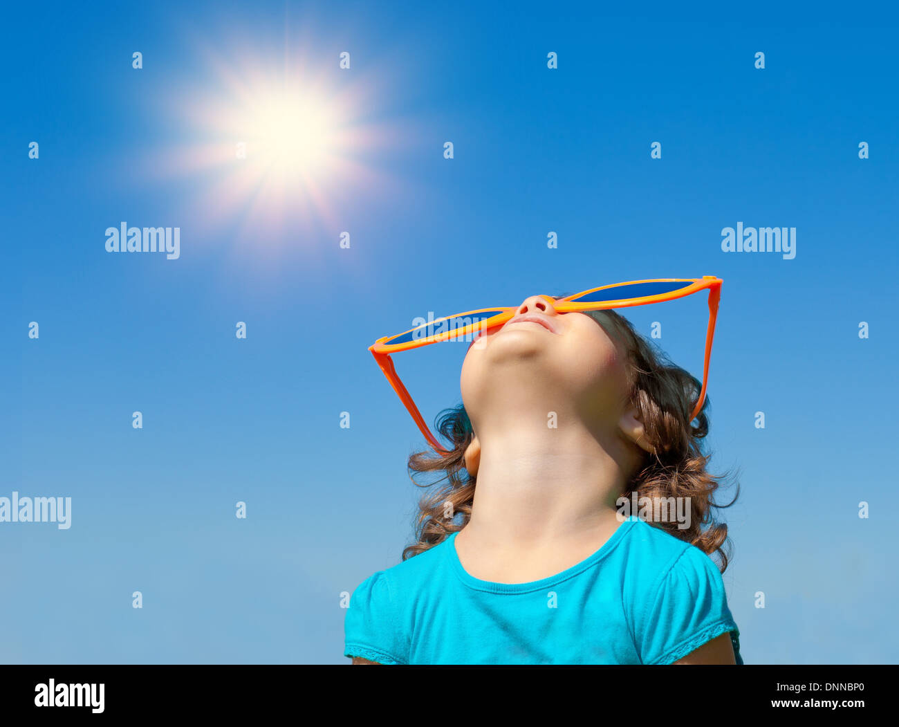 Happy little girl with big sunglasses looking at the sky Stock Photo ...