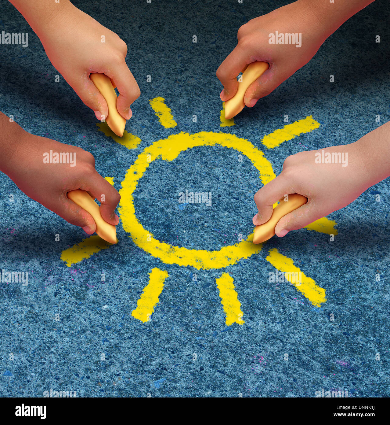 Community education and children learning and development concept with a group of hands representing ethnic groups of young people holding chalk cooperating together to draw a yellow sun shape as a metaphore for friendship. Stock Photo