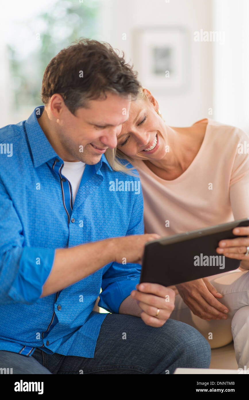 Couple using tablet pc at home Stock Photo