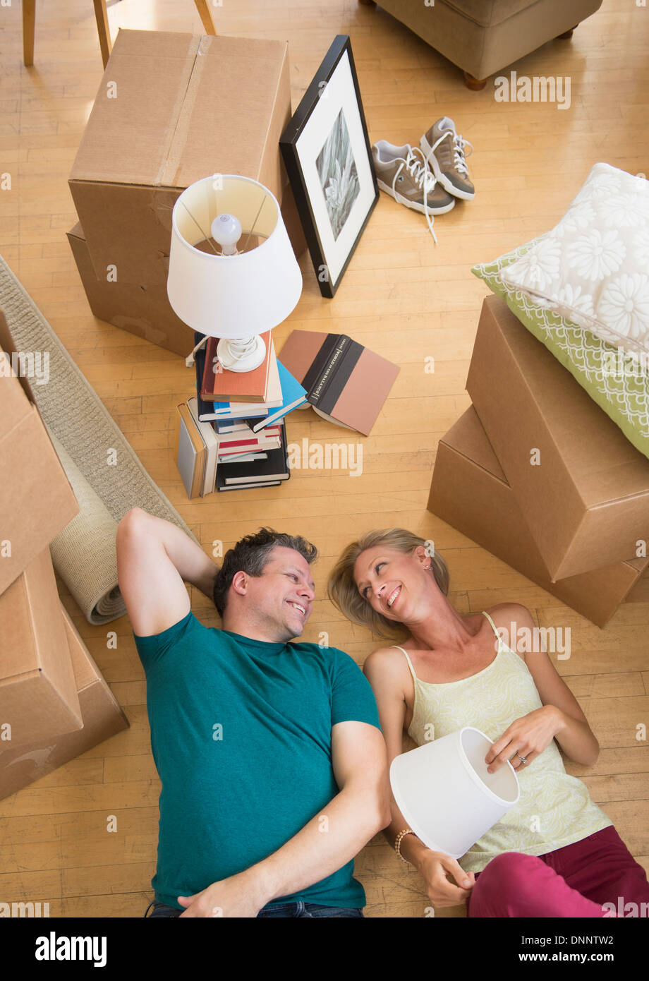 Couple lying on floor of new home Stock Photo