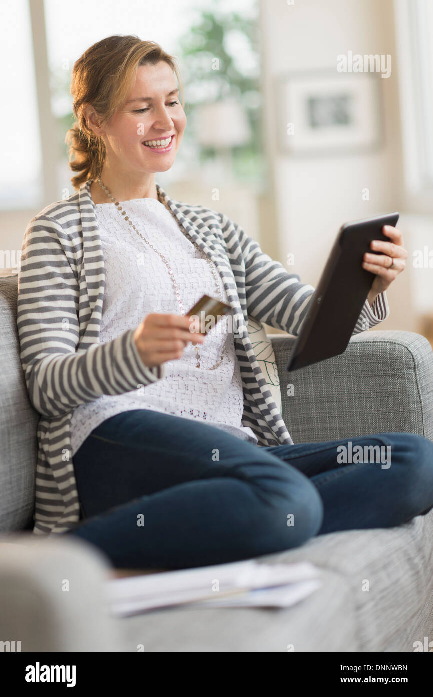 Woman holding tablet pc and credit card Stock Photo