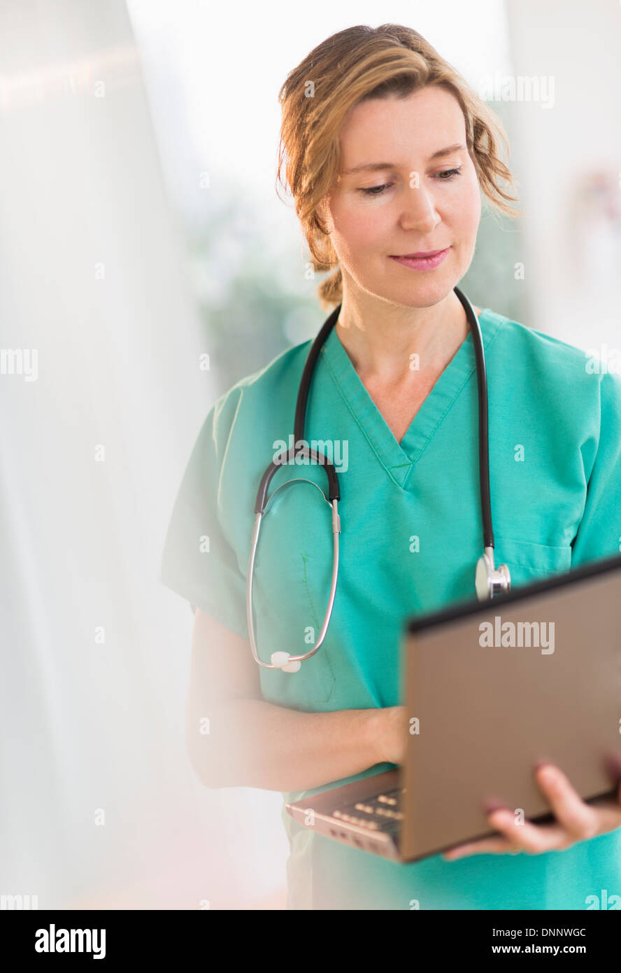 Female doctor using laptop Stock Photo