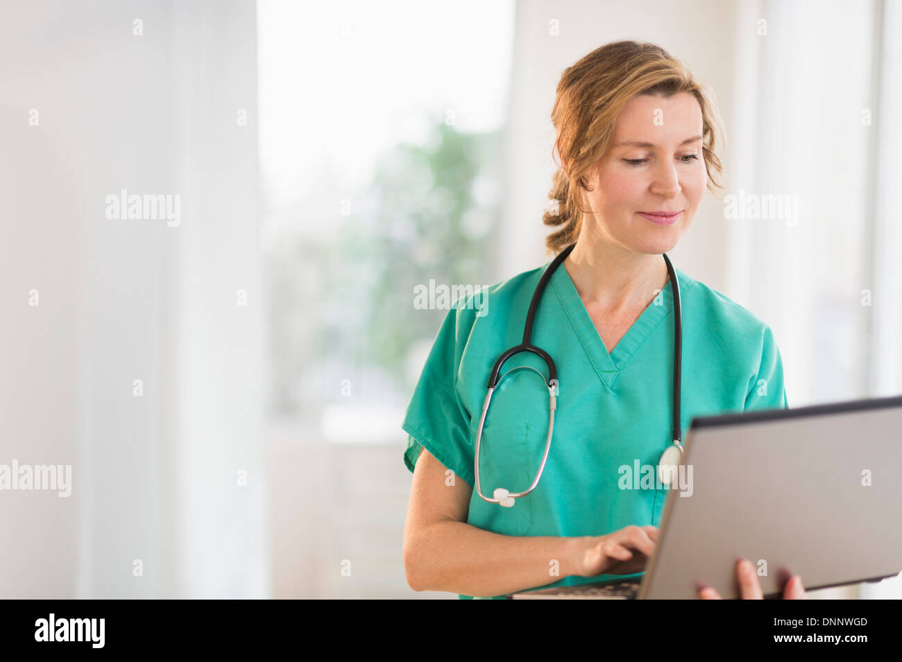 Female doctor using laptop Stock Photo