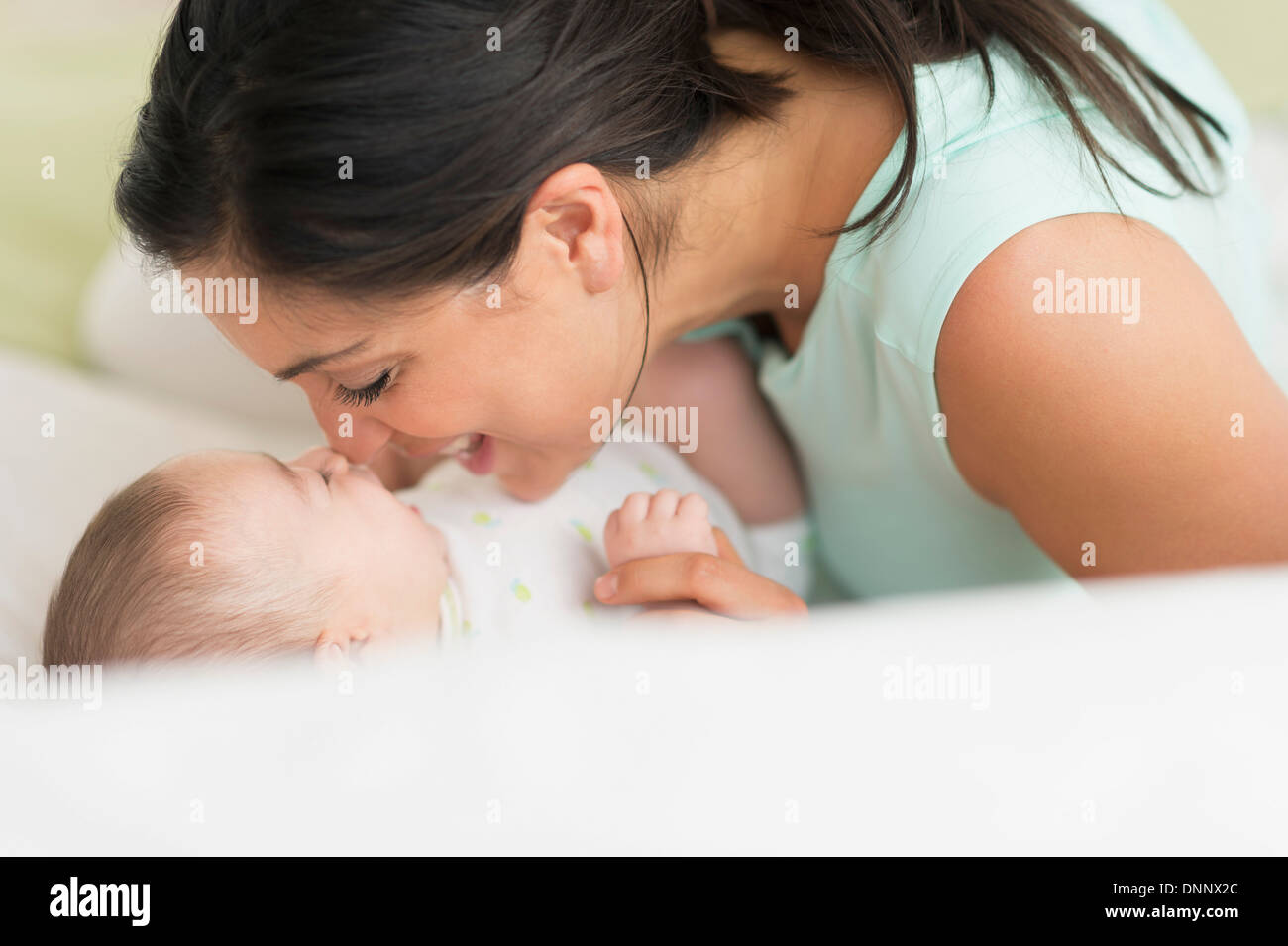 Mother and baby (2-5 months) lying on bed Stock Photo