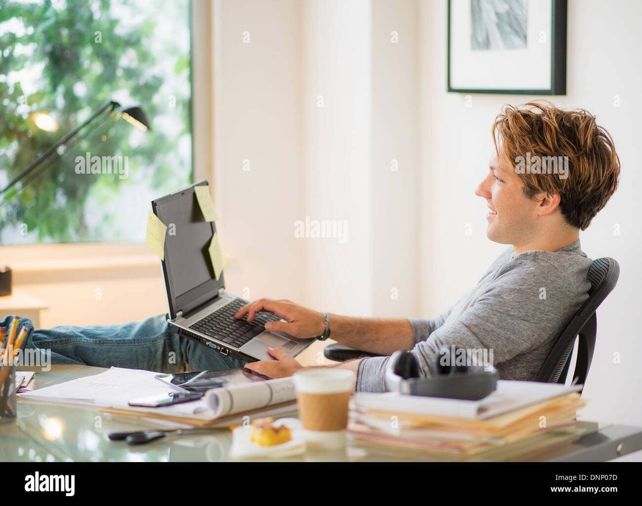 Man using laptop in home office Stock Photo