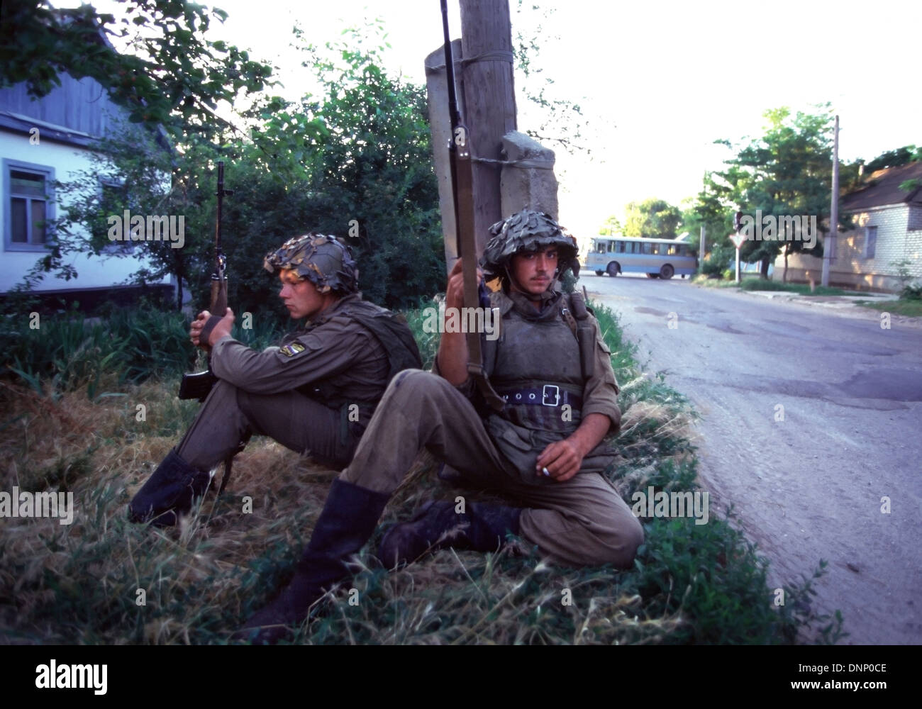 Russian Interior Ministry soldiers wearing body armor, hold Kalashnikov rifles near the Budyonnovsk hospital in1995 Stock Photo