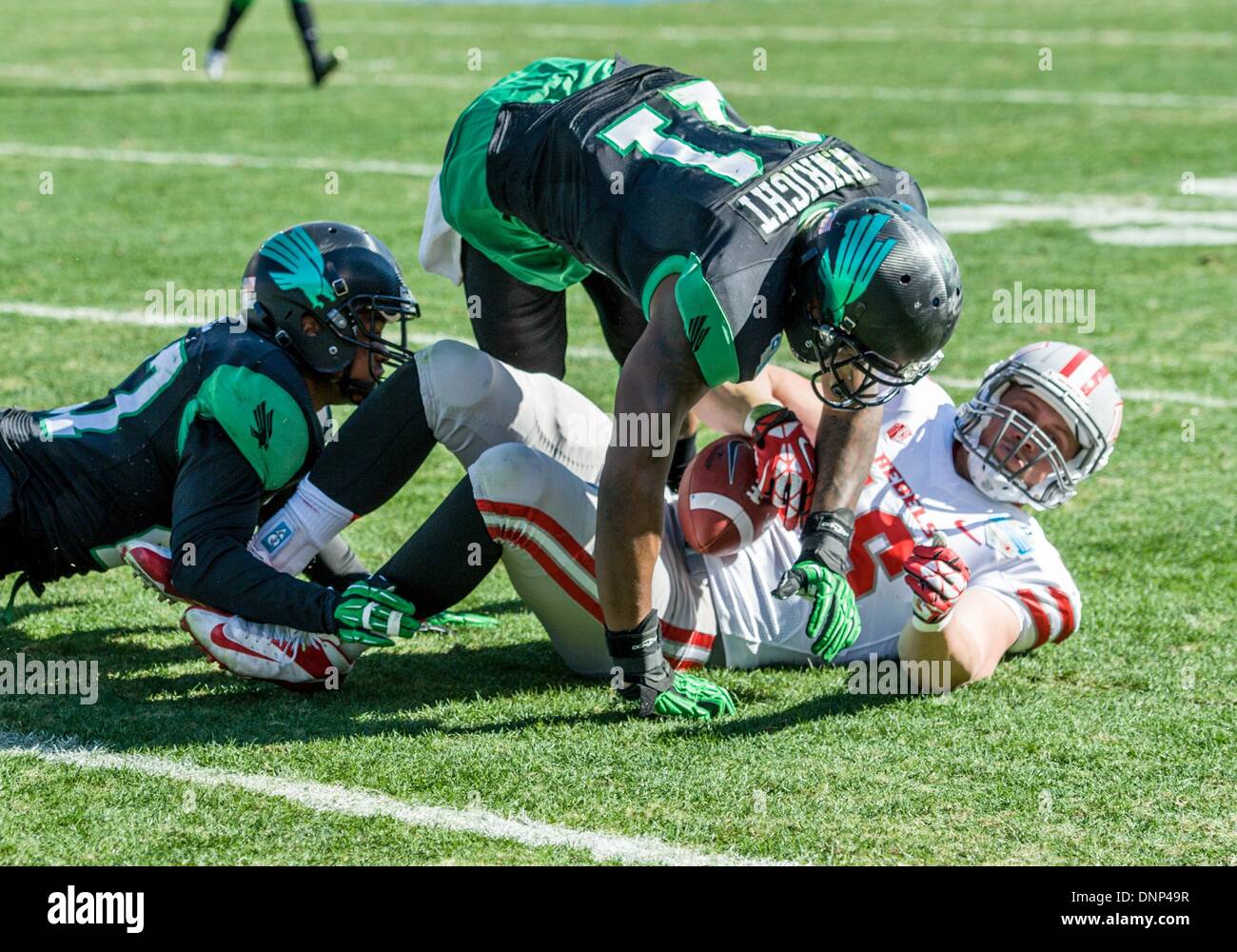 Dallas, Texas, USA. January 1st, 2014: .UNLV Rebels tight end Taylor Barnhill (16) catches a pass as he is defended by North Texas Mean Green defensive back James Jones (13) and North Texas Mean Green linebacker Will Wright (11).during the 2014 Heart of Dallas Bowl football game between the University Las Vegas Nevada Rebels and the North Texas Mean Green Eagles at Cotton Bowl Stadium in Dallas, Texas. Credit:  Cal Sport Media/Alamy Live News Stock Photo