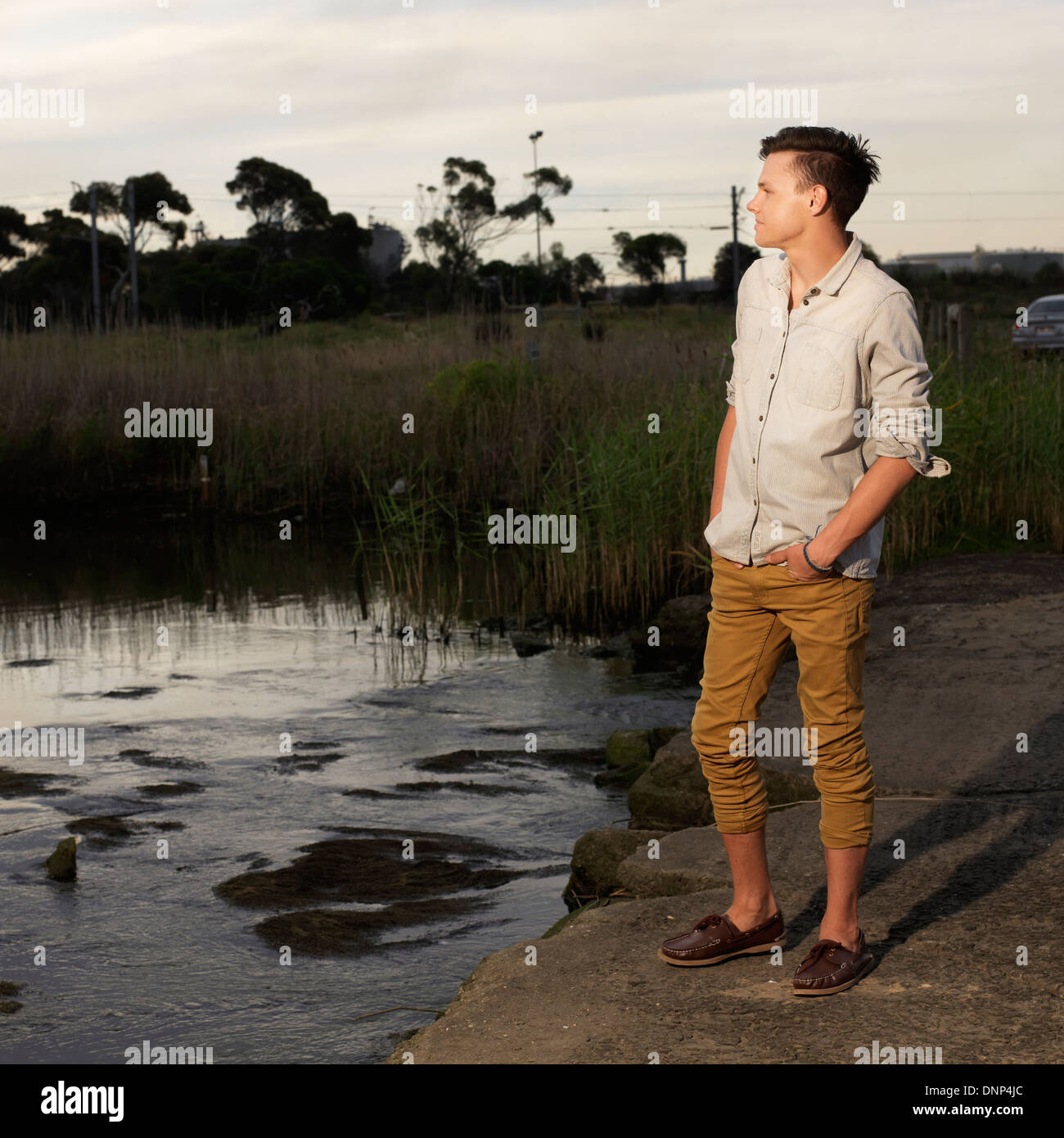 evening scene of young man looking into the distance Stock Photo