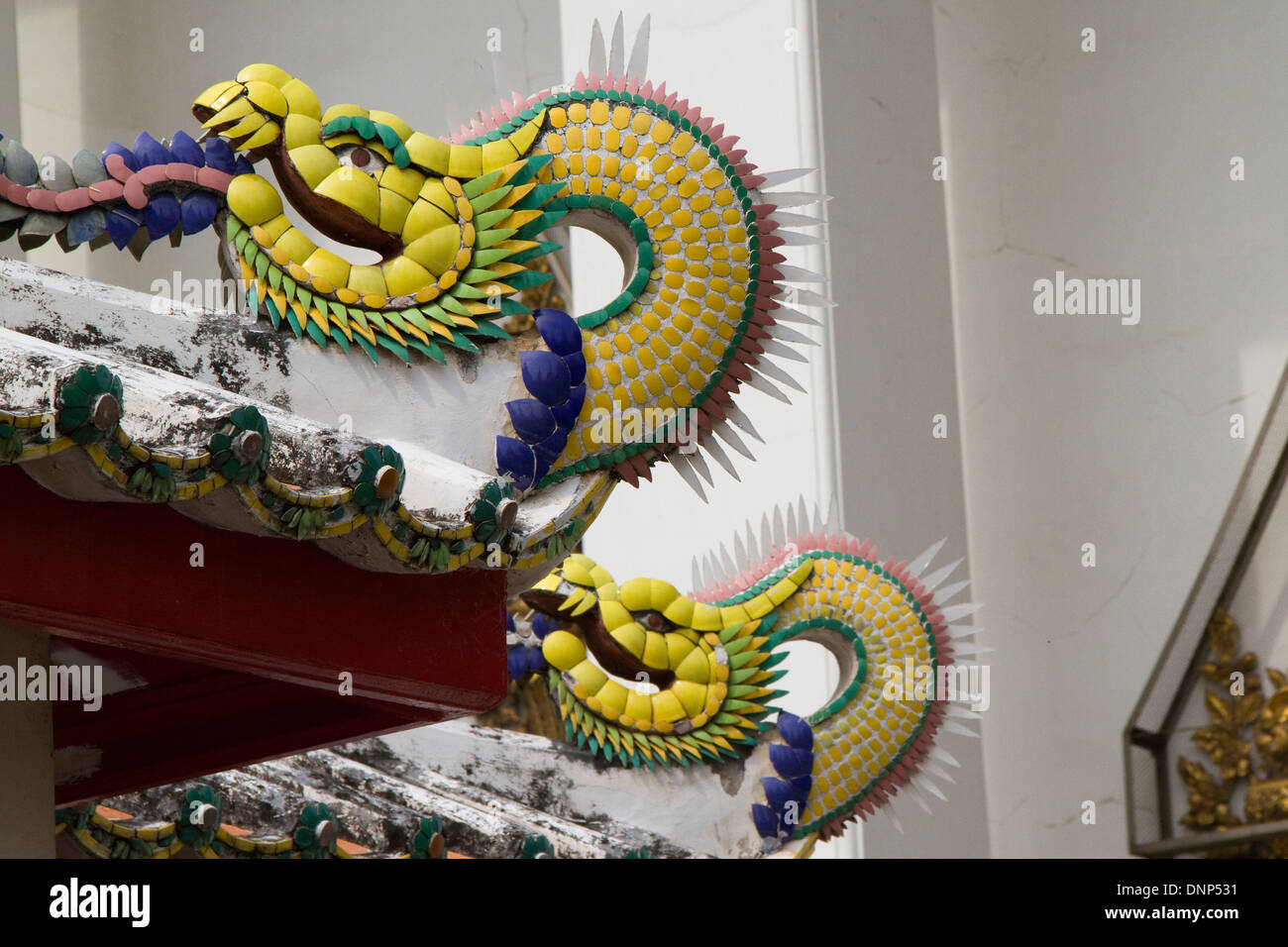 Ceramics dragons decorate the eves of a Buddhist temple in Wat Po.Bangkok,Thailand Stock Photo