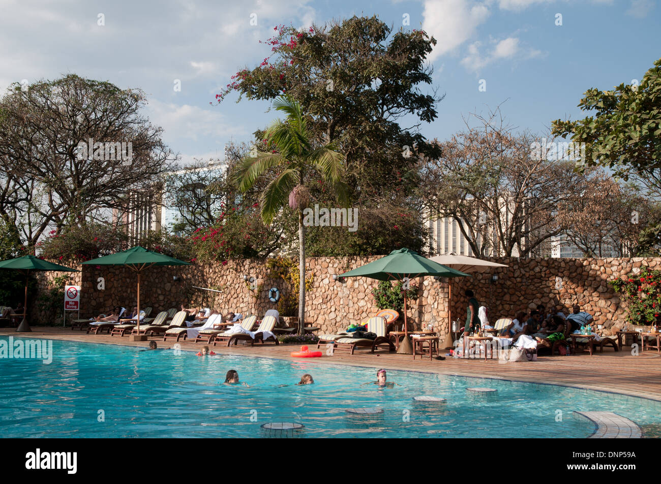Swimmers enjoying a swim in the Nairobi Serena Hotel swimming pool Nairobi Kenya Stock Photo