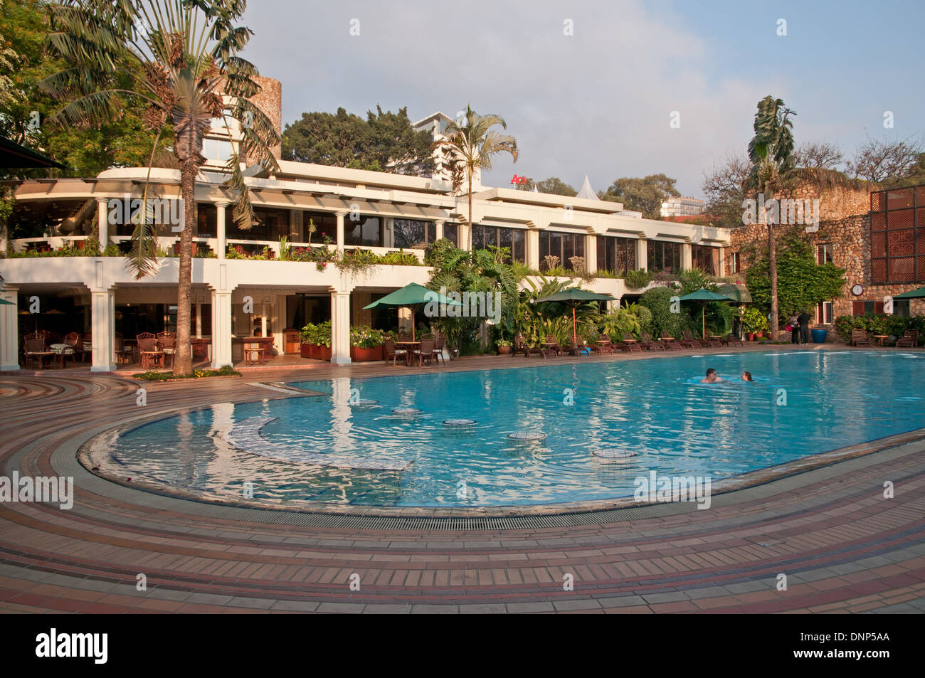 Nairobi Serena Hotel swimming pool with two swimmers Kenya Stock Photo