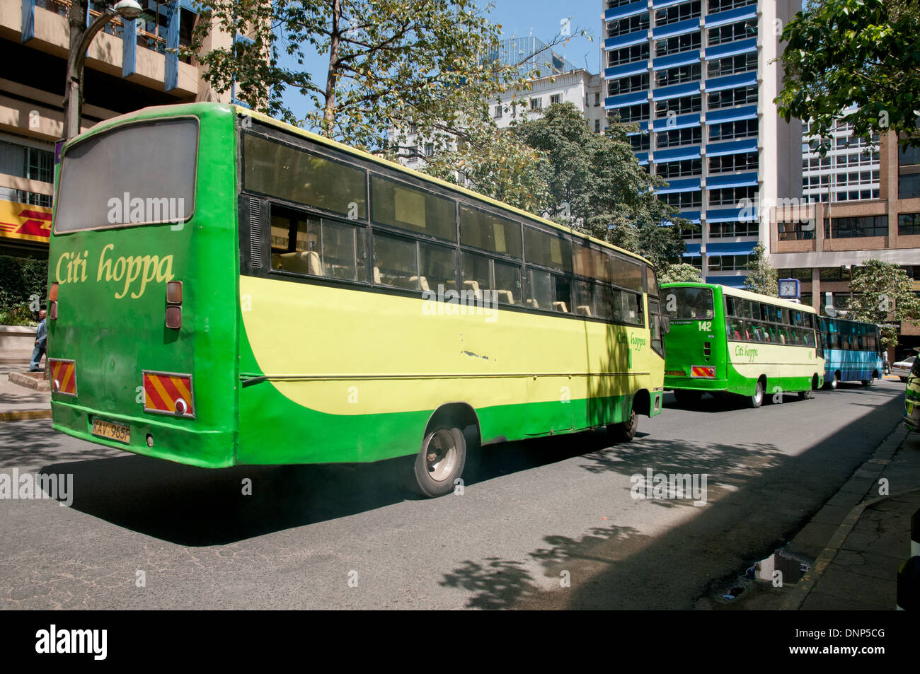 Two green Citi Hoppa Buses and blue KBS Kenya Bus Service bus on Simba Street in central Nairobi Kenya Stock Photo