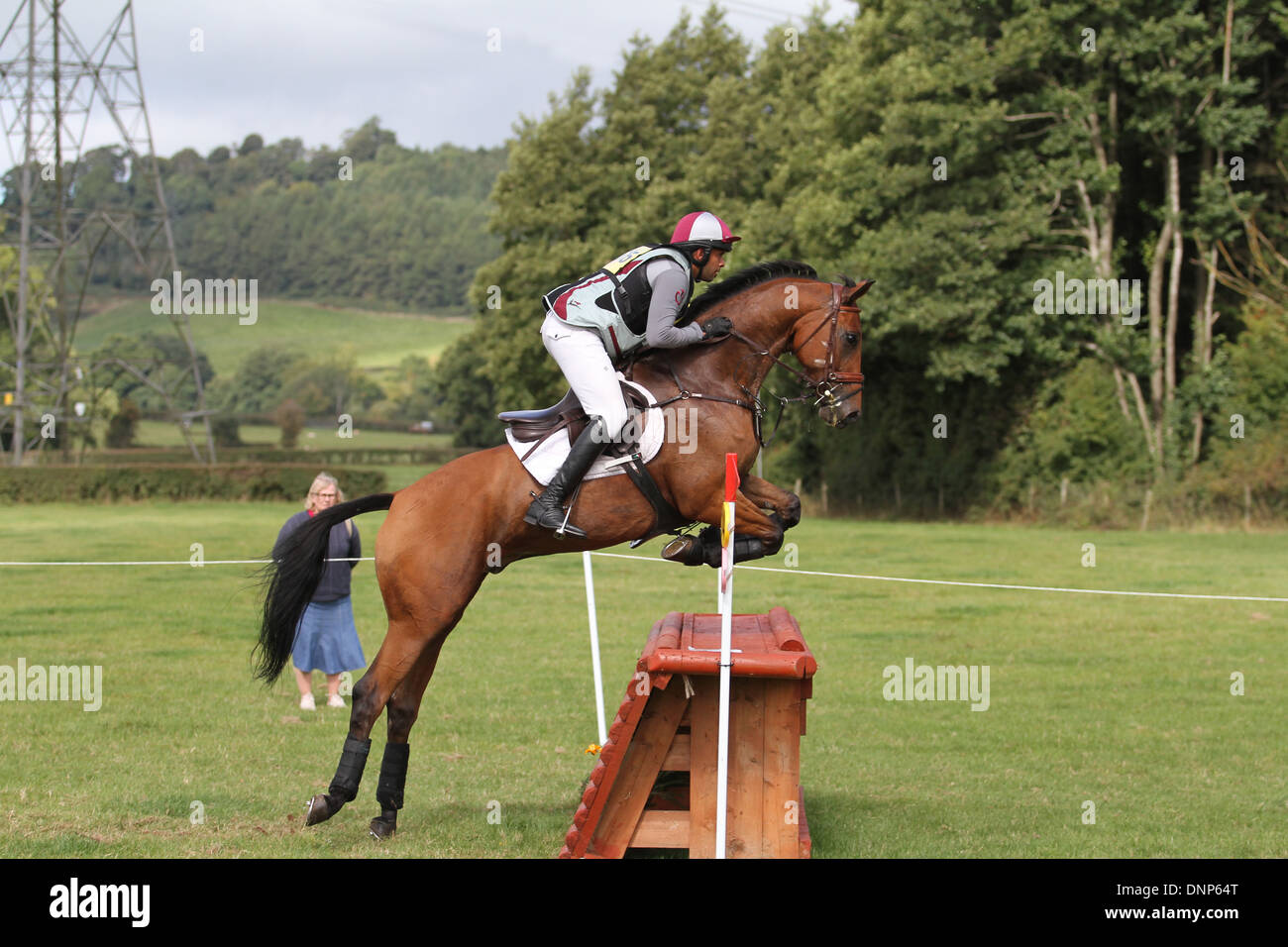 Horse and rider jumping a fence during the cross country phase of a one day event Stock Photo