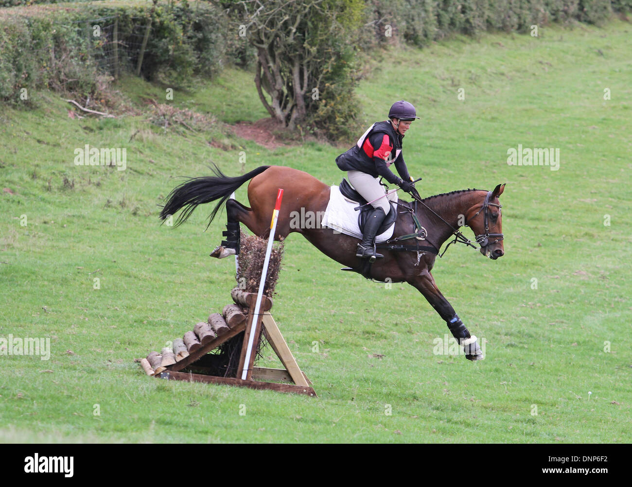 Horse and rider jumping a fence during the cross country phase of a one