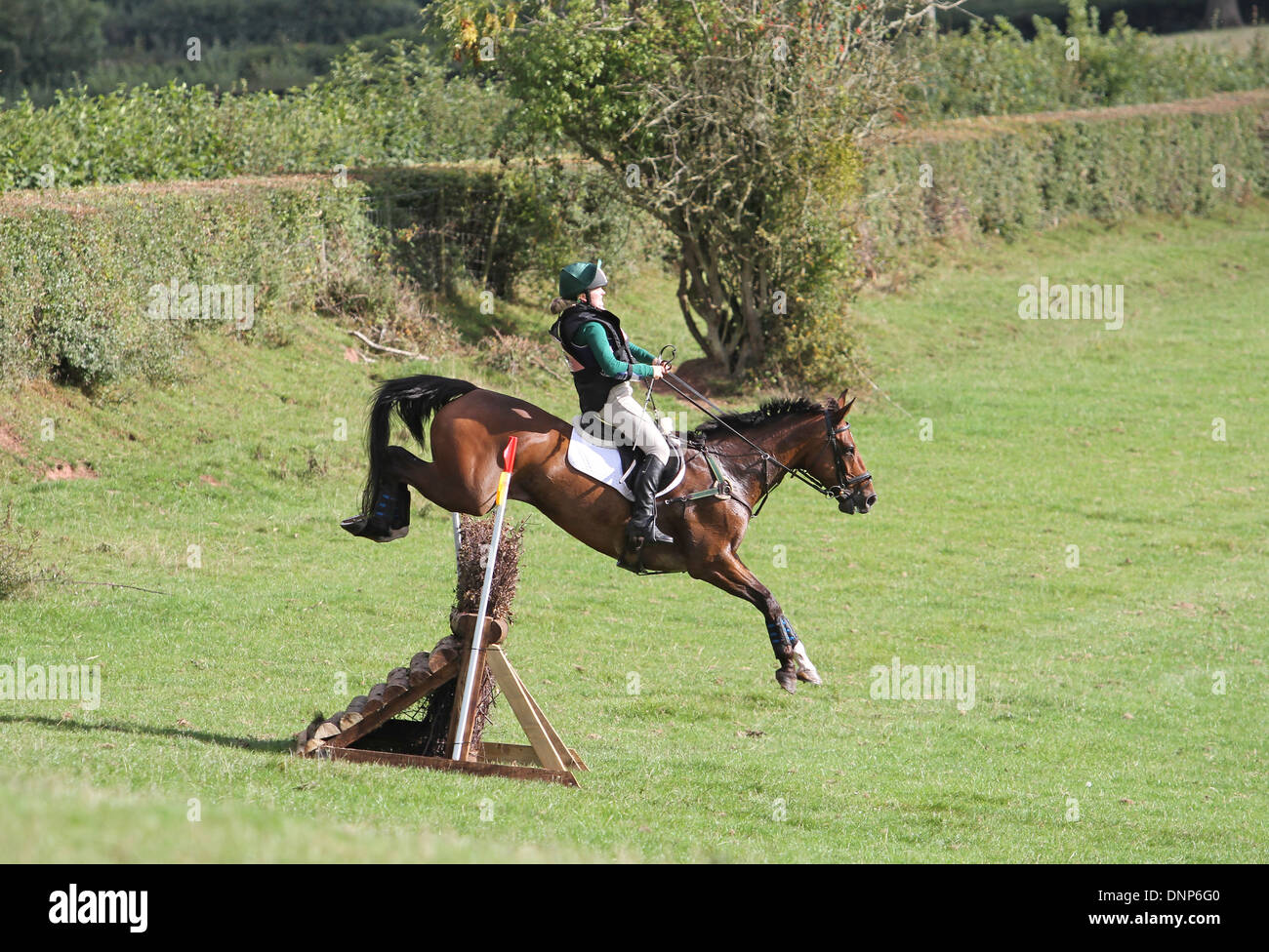 Horse and rider jumping a fence during the cross country phase of a one