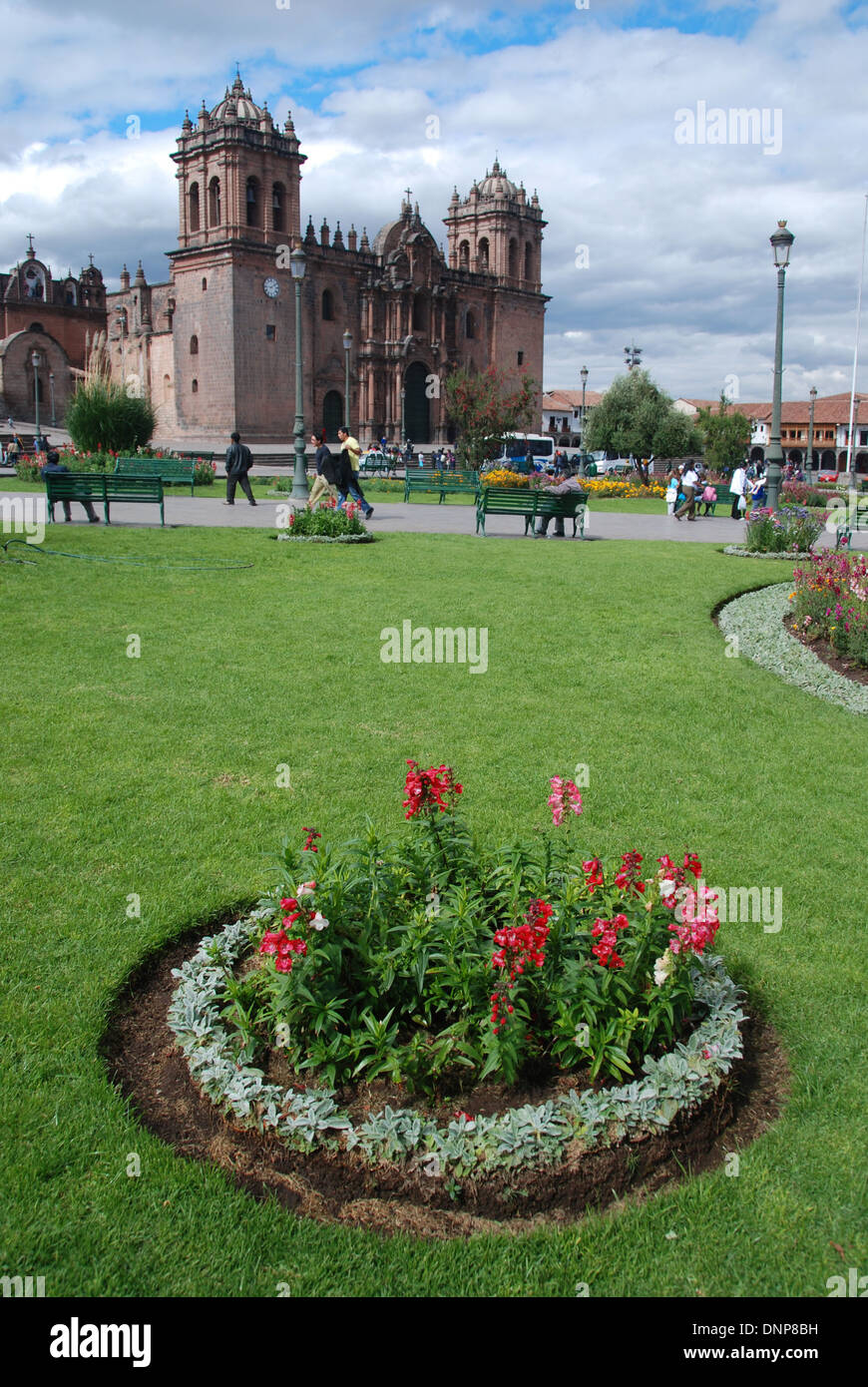 View of Cuzco Cathedral in Peru, with park flowers in the foregound Stock Photo
