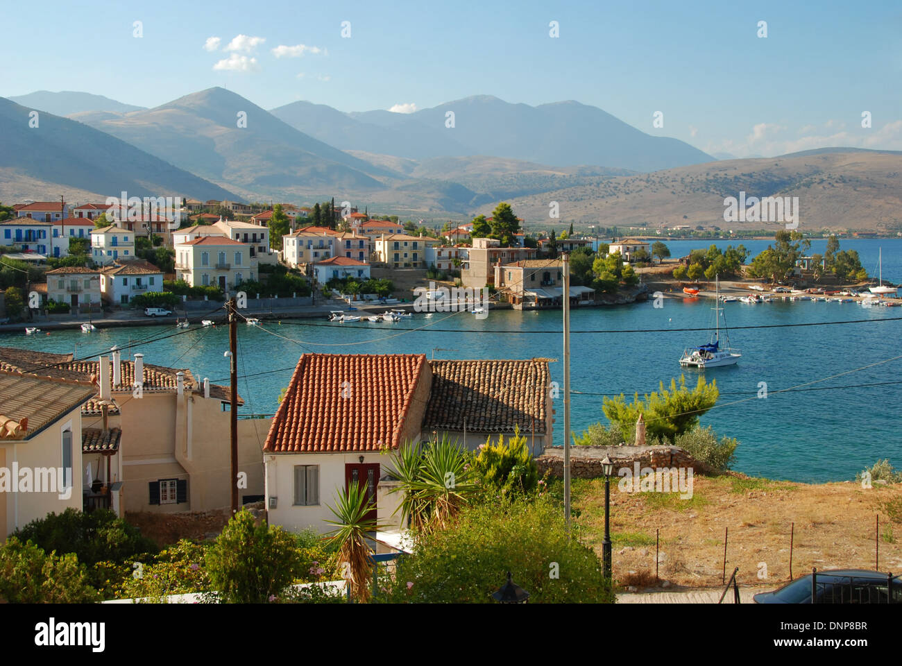 View of the harbour in Galaxidi, Greece, with the mountainous landscape behind Stock Photo