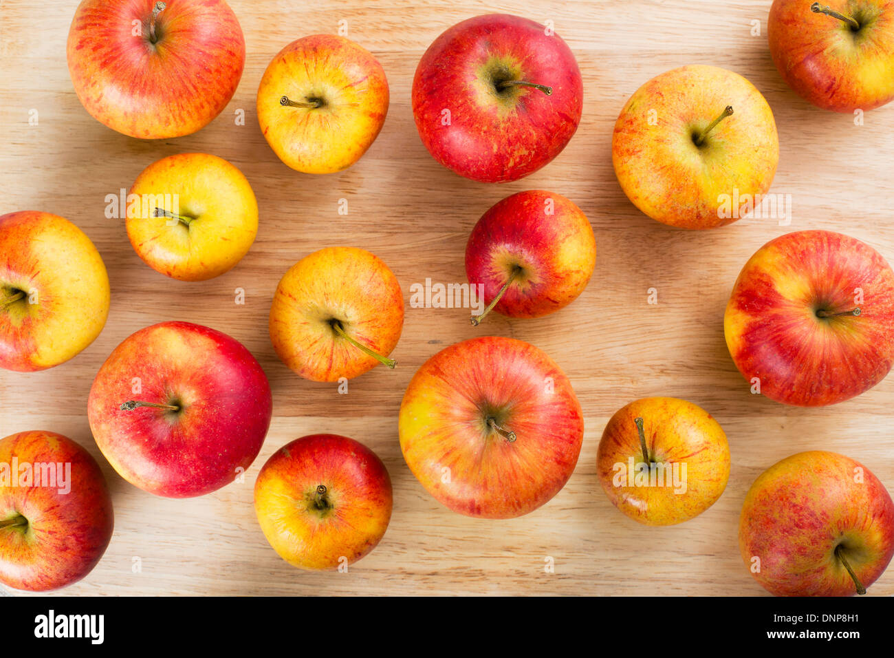 Red and yellow apples on table viewed from above. Stock Photo