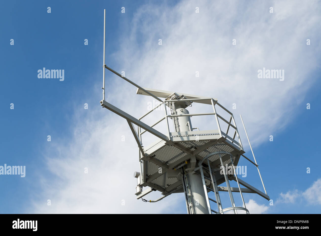 Iron tower with radar and radio communication equipment Stock Photo