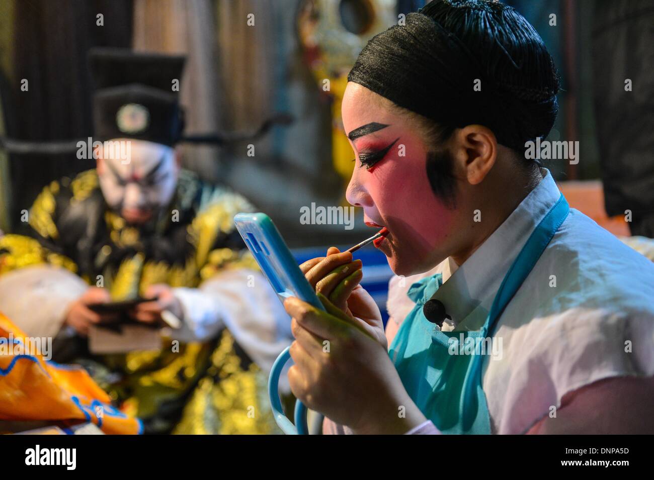 Wuyi, China's Zhejiang Province. 3rd Jan, 2014. An actor of a local traditional opera troupe makes up himself before performing at Wuyi County in Jinhua City, east China's Zhejiang Province, Jan. 3, 2014. The Wu Opera, also called Jinhua Opera, is a local traditional opera with a histoy of more than 400 years. Wu Opera troups here would perform for local residents to celebrate festivals like the New Year. © Xu Yu/Xinhua/Alamy Live News Stock Photo