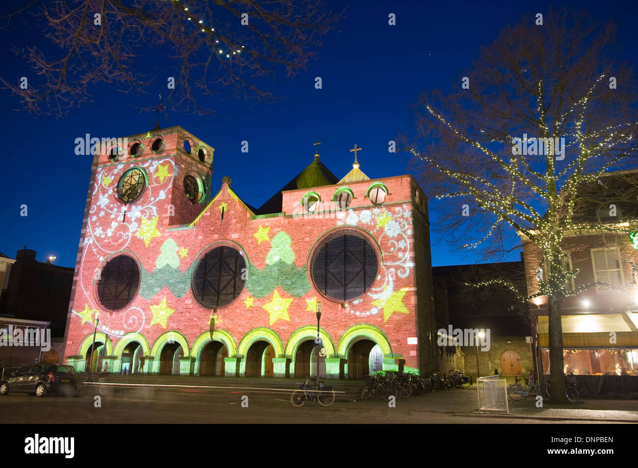 In the center of the Dutch city Enschede the main church is being lighted by a  beamer with color effects because of christmas Stock Photo