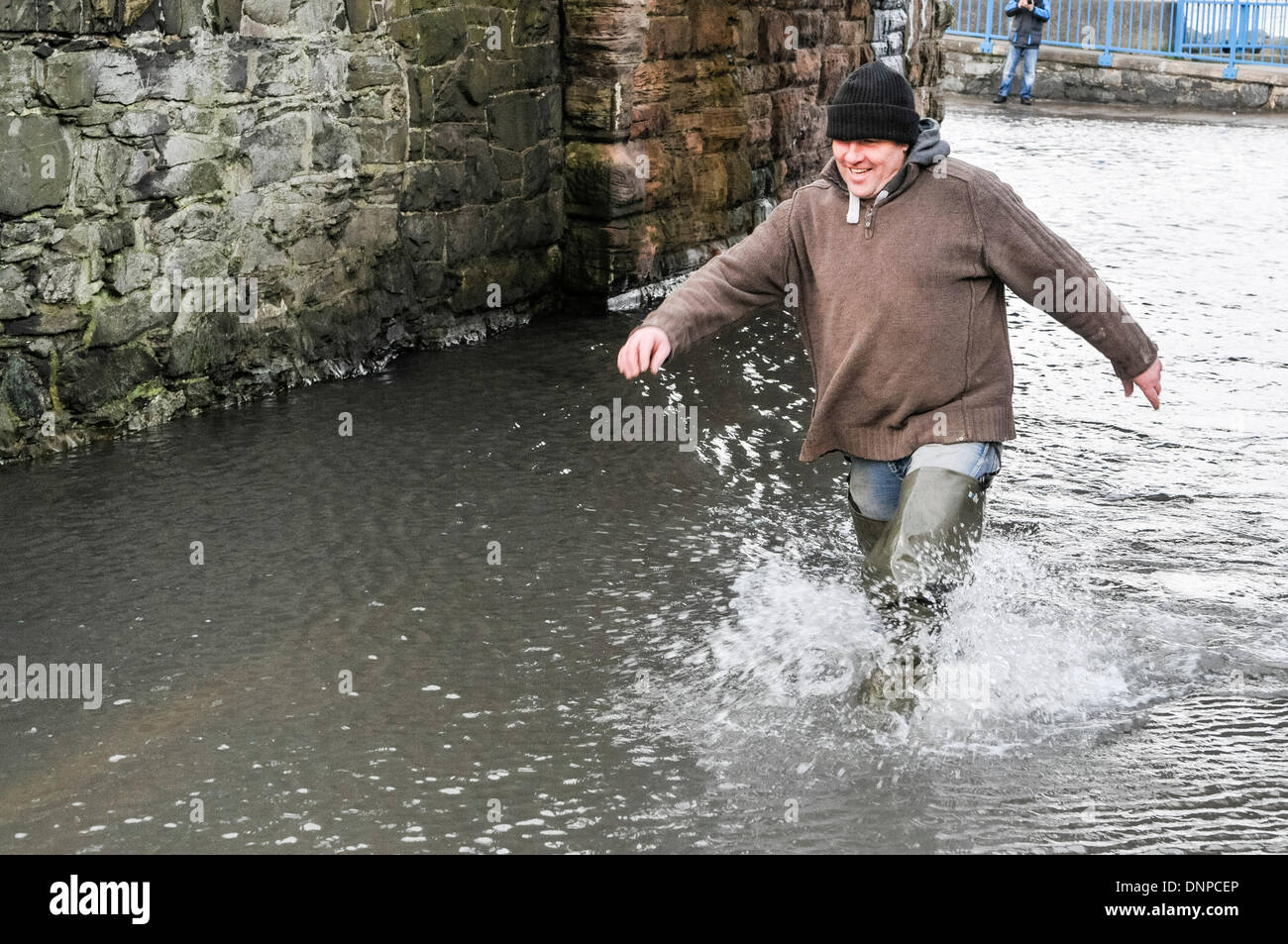 Holywood, Northern Ireland. 3 Jan 2013 -  A man walks through floodwater at Holywood Esplanade Credit:  Stephen Barnes/Alamy Live News Stock Photo