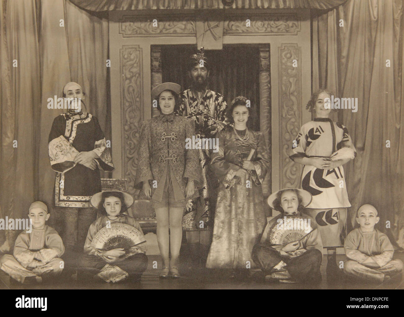 A photograph of Princess Margaret (centre right) and Princess Elizabeth (centre left) in the play Aladdin, 1943 Stock Photo