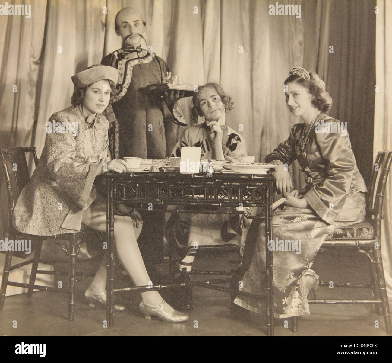 A photograph of Princess Margaret (right) and Princess Elizabeth (left) in the play Aladdin, 1943 Stock Photo
