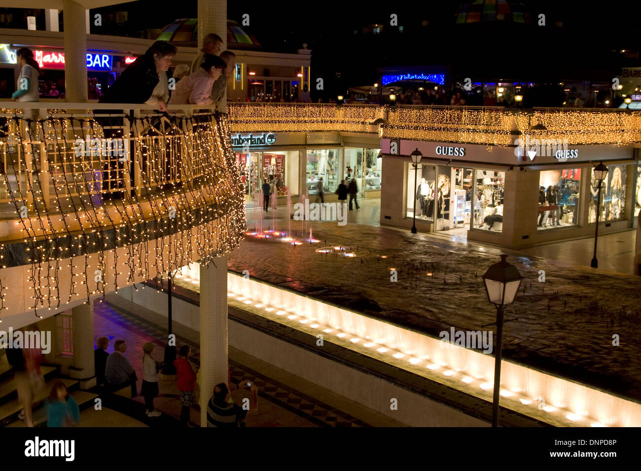shopping centre and fountain lit up at night, Playa de Las Americas, Tenerife, Spain Stock Photo