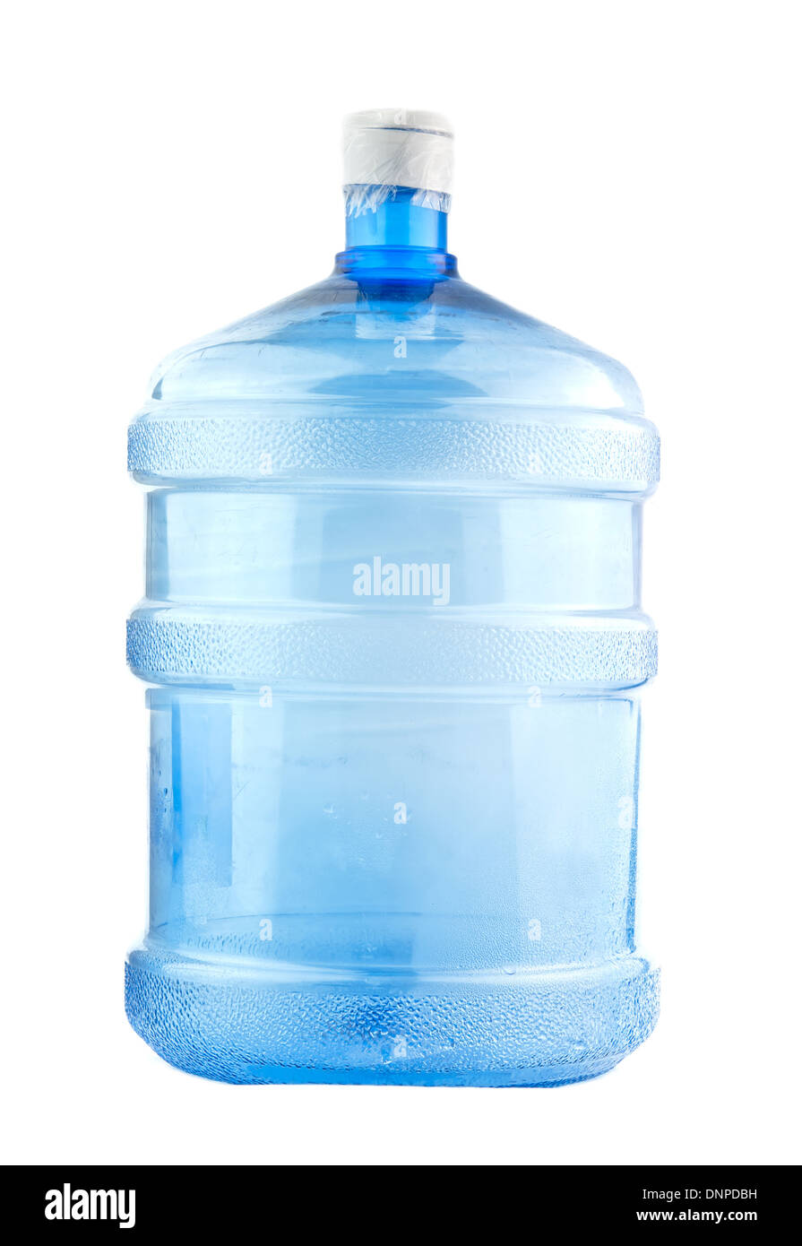 Big plastic bottle with water on the table over bright kitchen backgroung.  Bottle of clear transarent water in a blue color cap and handle closeup  Stock Photo - Alamy