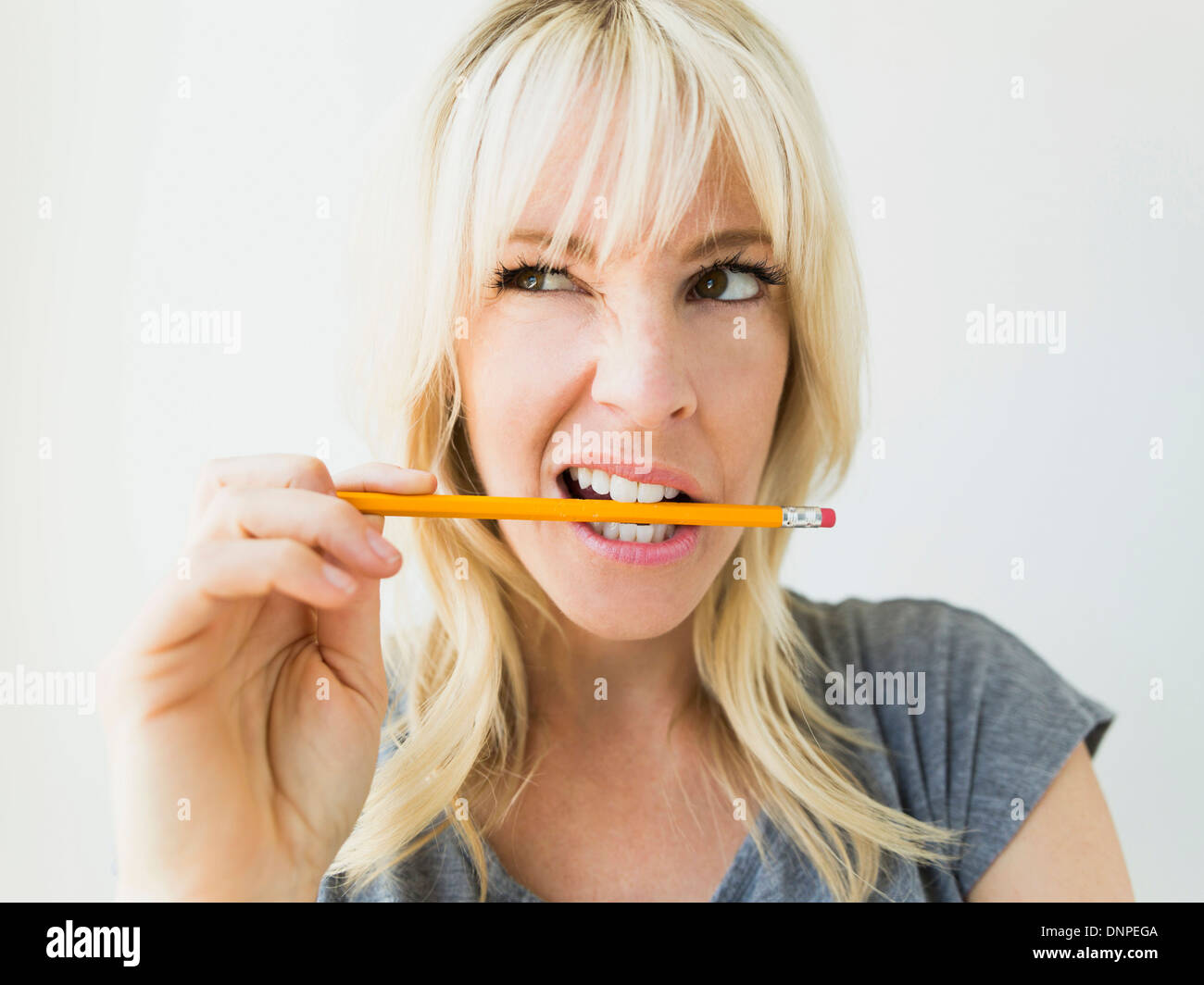 Angry woman biting pencil hires stock photography and images Alamy