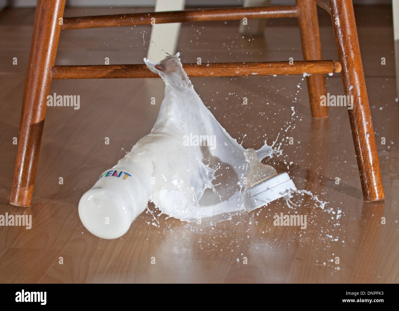 Baby milk dropping to the floor Stock Photo