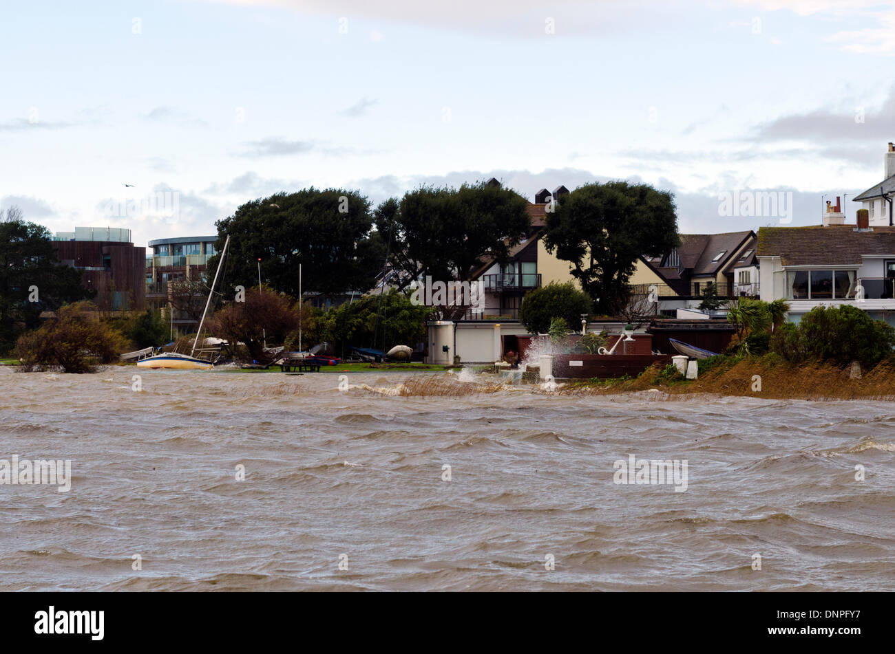 Christchurch, UK. 03rd Jan, 2014. Yacht breaks mooring, drifts ashore. Local harbourside houses battered by storm winds and waves with some flooding Credit:  Roger Allen Photography/Alamy Live News Stock Photo