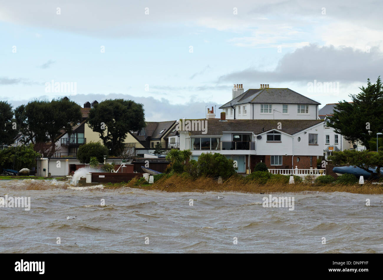 Christchurch, UK. 03rd Jan, 2014. Local harbourside houses battered by storm winds and waves with some flooding Credit:  Roger Allen Photography/Alamy Live News Stock Photo