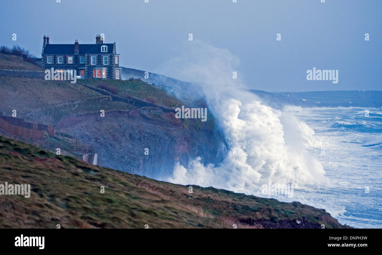 Huge storm waves batter the cliffs Cornish coast at Porthleven Stock Photo