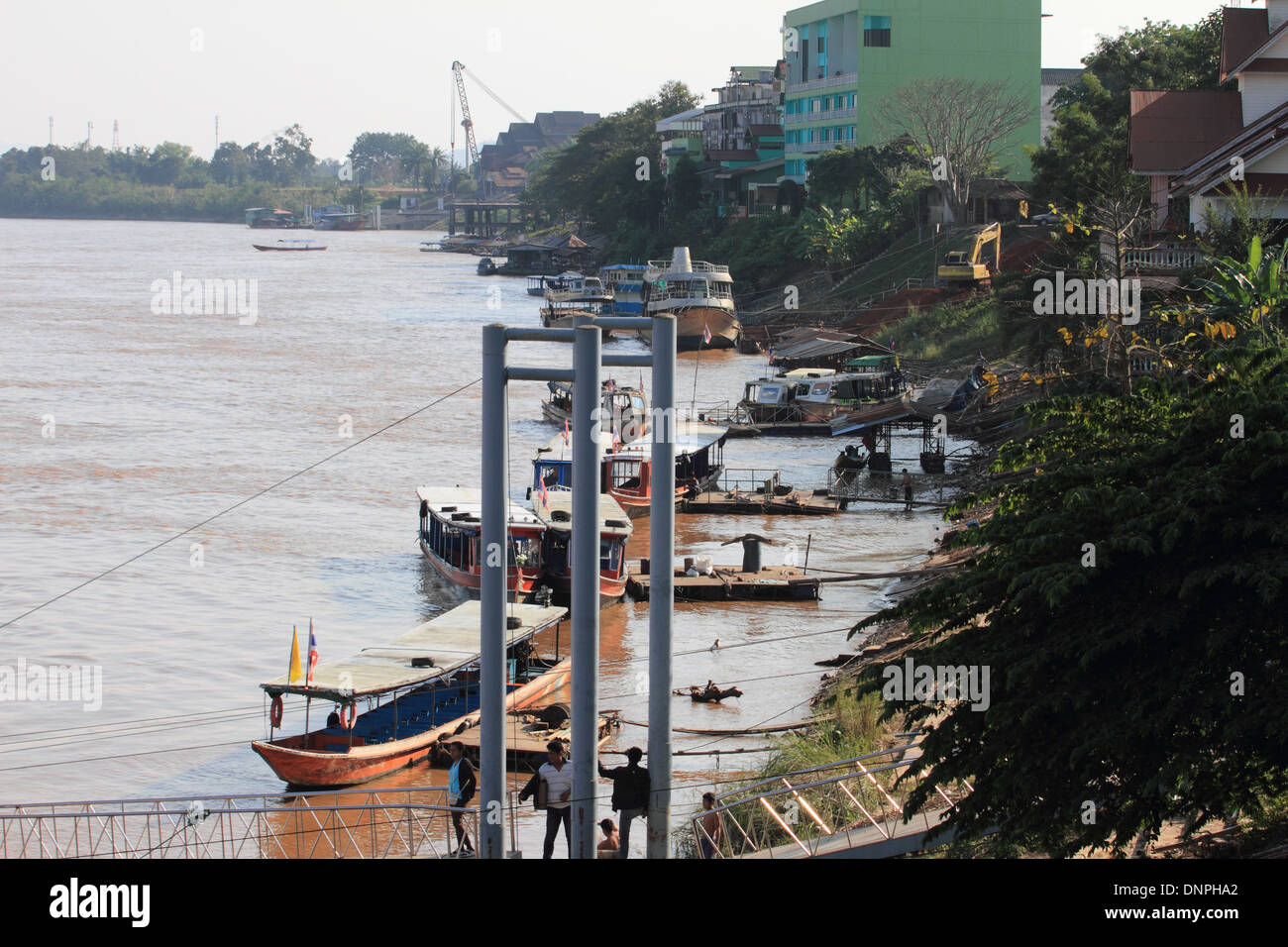 longtail boats along Thai mekong riverbank Stock Photo