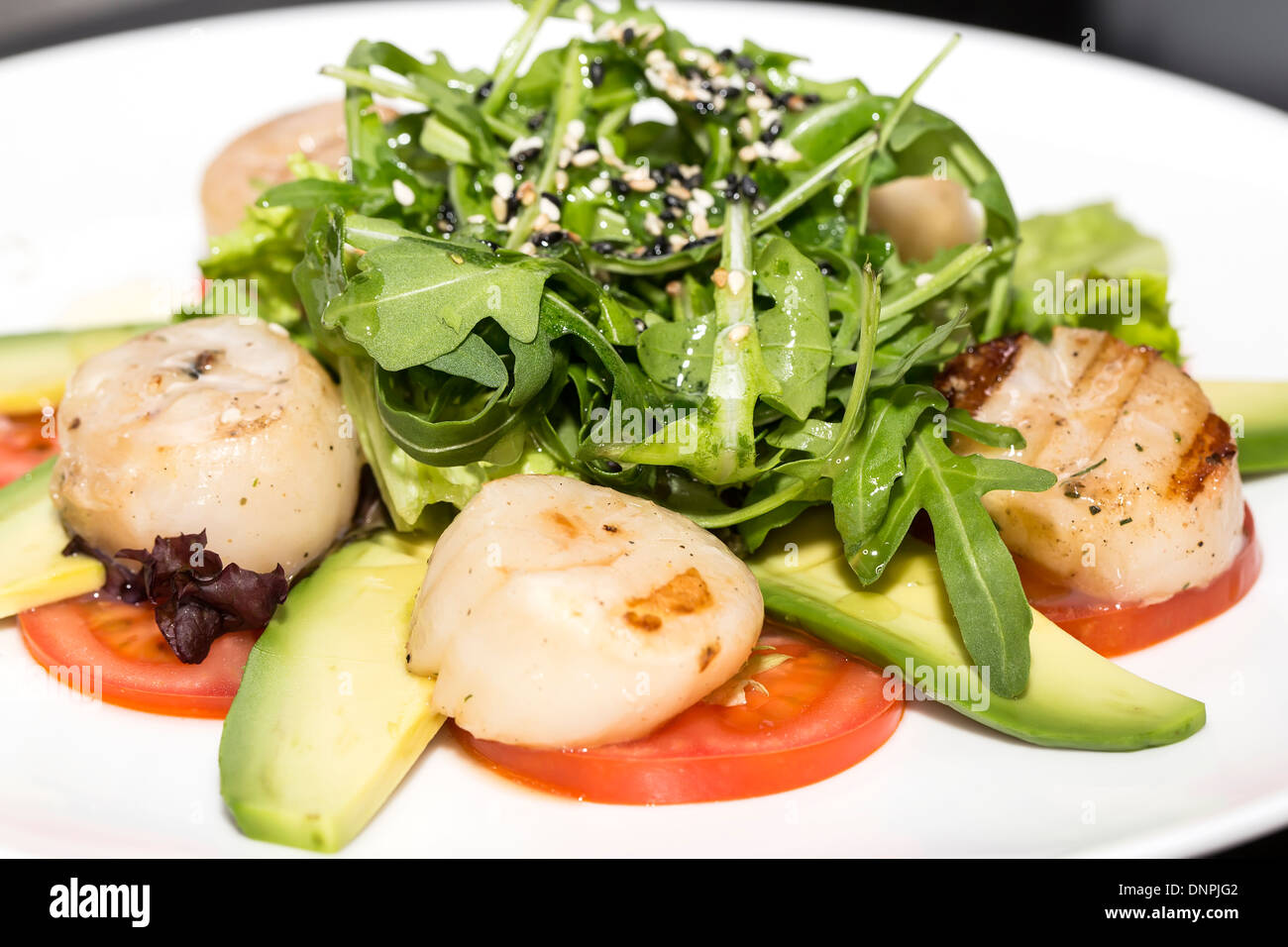 scallops grilled with avocado and tomatoes Stock Photo Alamy