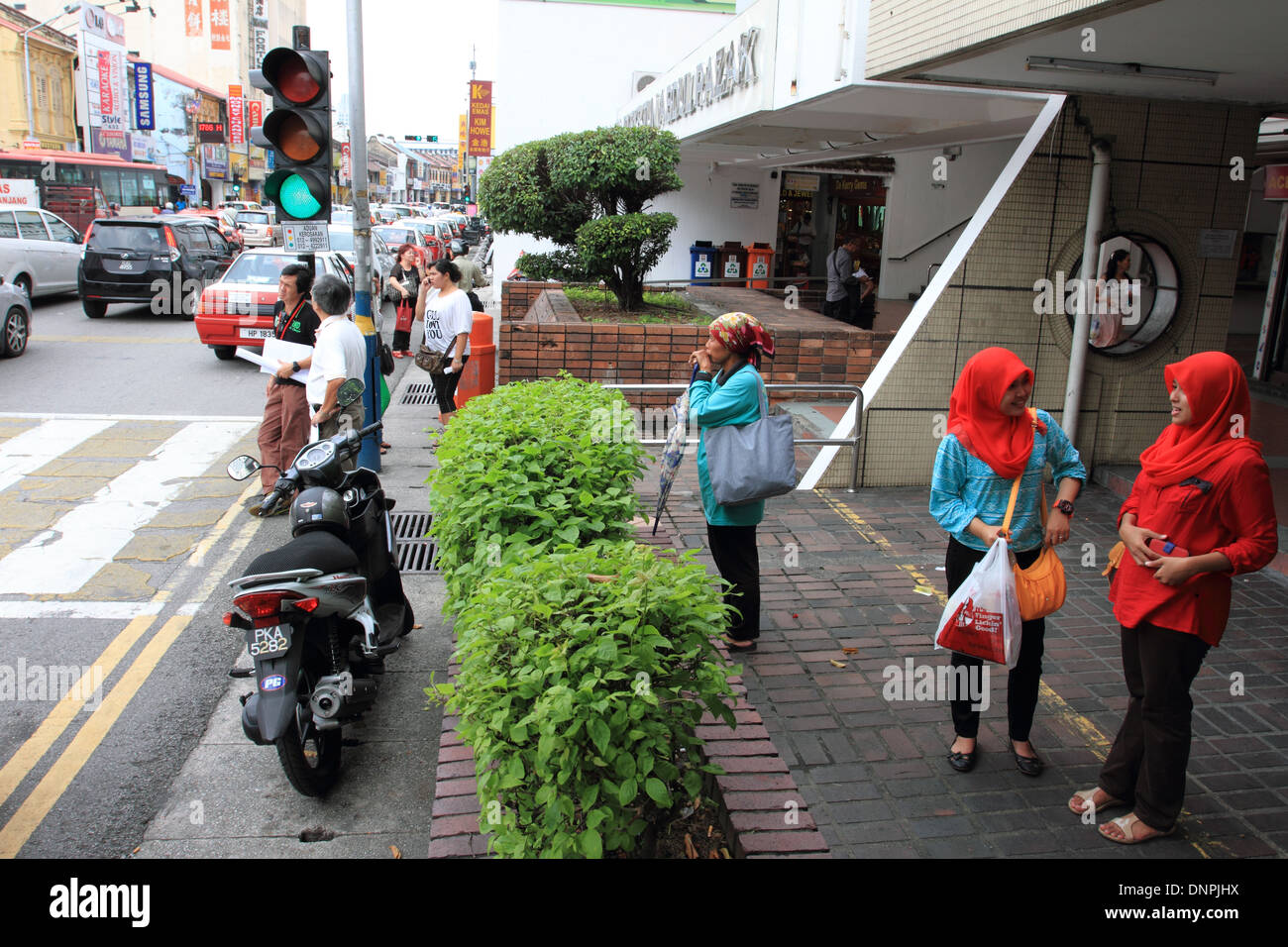 malay women waiting outside old komtar, penang,malaysia Stock Photo