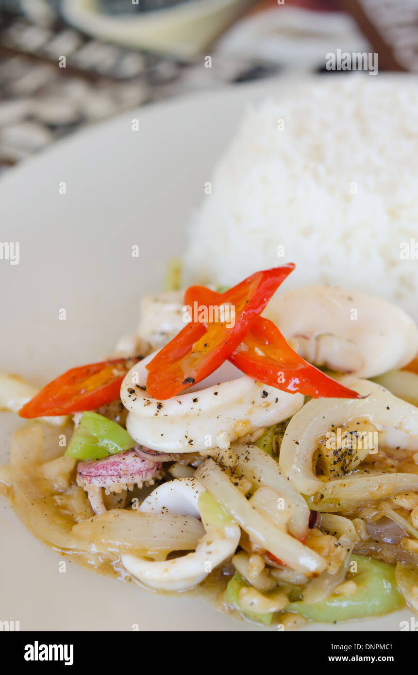 stir fried squid and vegetable served with steamed rice , spicy food
