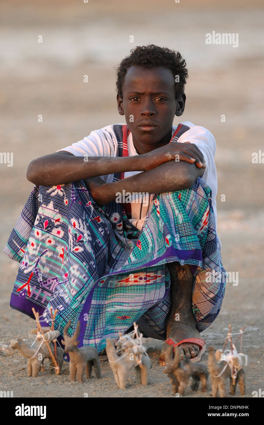 Teenager boy selling small animal statues in Lake Abbe in Djibouti, Horn of Africa Stock Photo